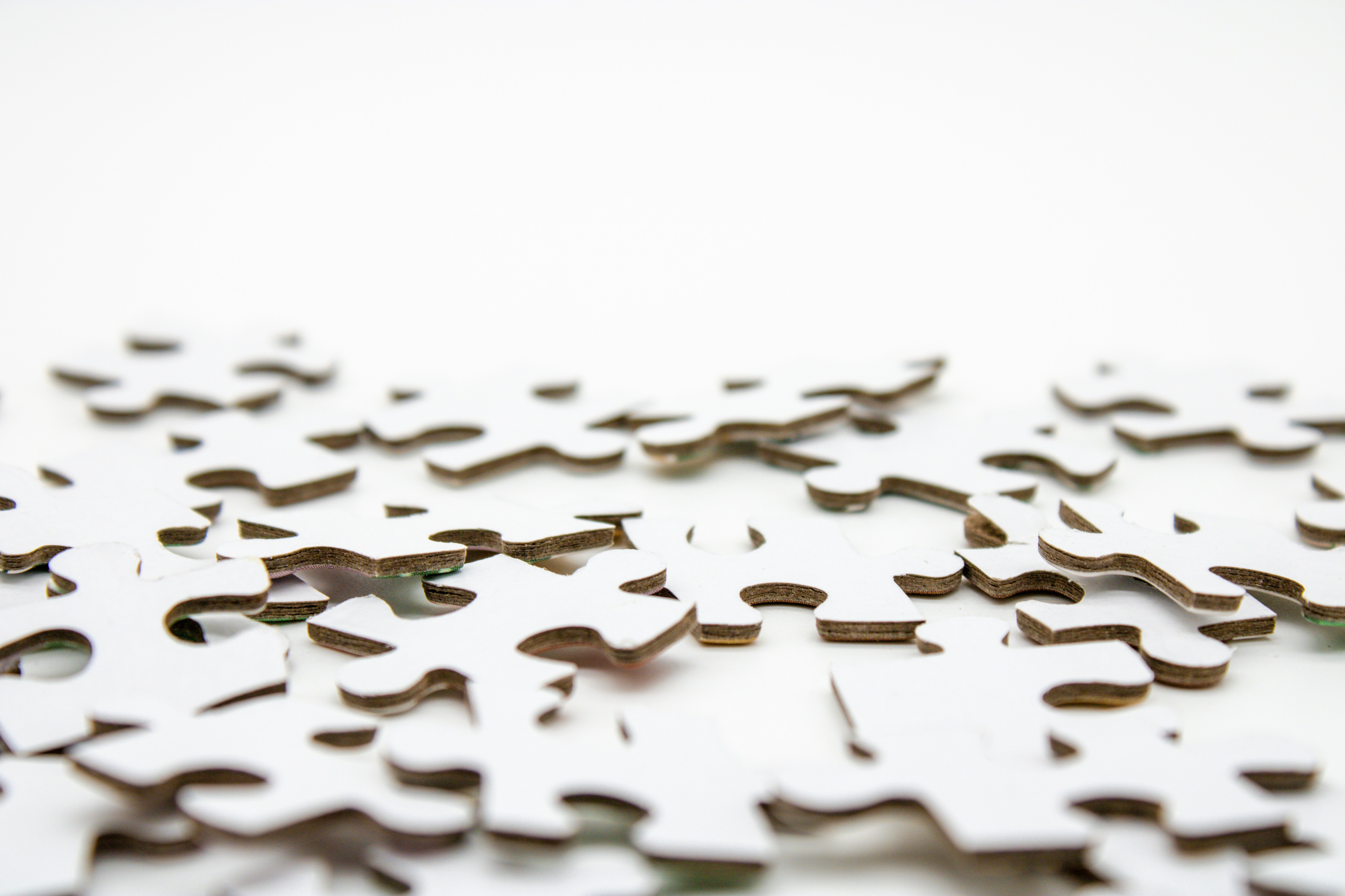 Spread out puzzles symbolizing the complexity of human experience